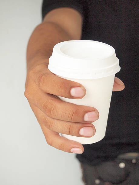 istock man offering a cup of coffee 465950721