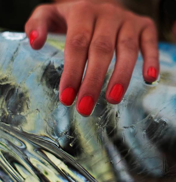istock Ladies fingernail hand on ice block 465951282