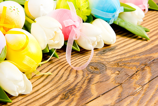 Colorful Easter eggs on wooden board
