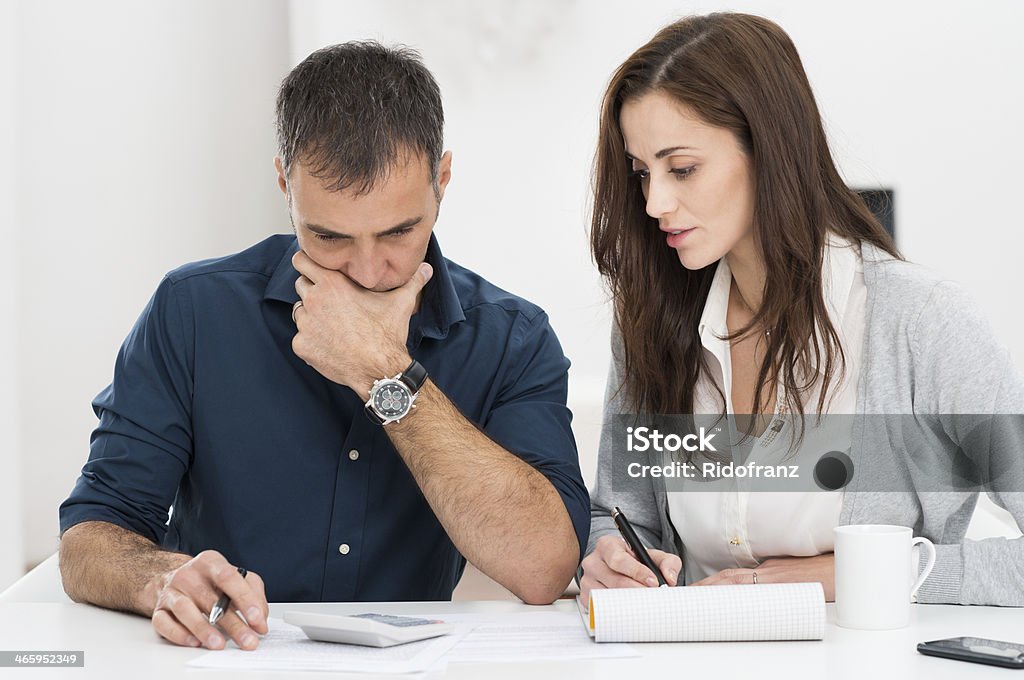 Couple Calculating Budget Portrait Of A Worried Couple Calculating Financial Budget Couple - Relationship Stock Photo