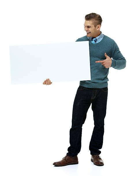 istock Cheerful smart casual man pointing at placard 465952552
