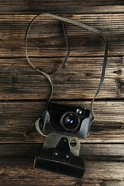 istock Old retro camera on brown wooden background 465952960