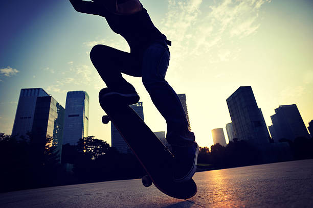 istock skateboarding woman jumping at  sunrise 465953114