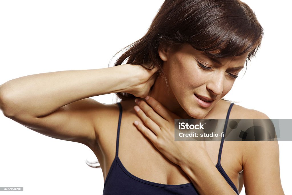 Woman with neck pain Young woman holding her aching neck Adult Stock Photo