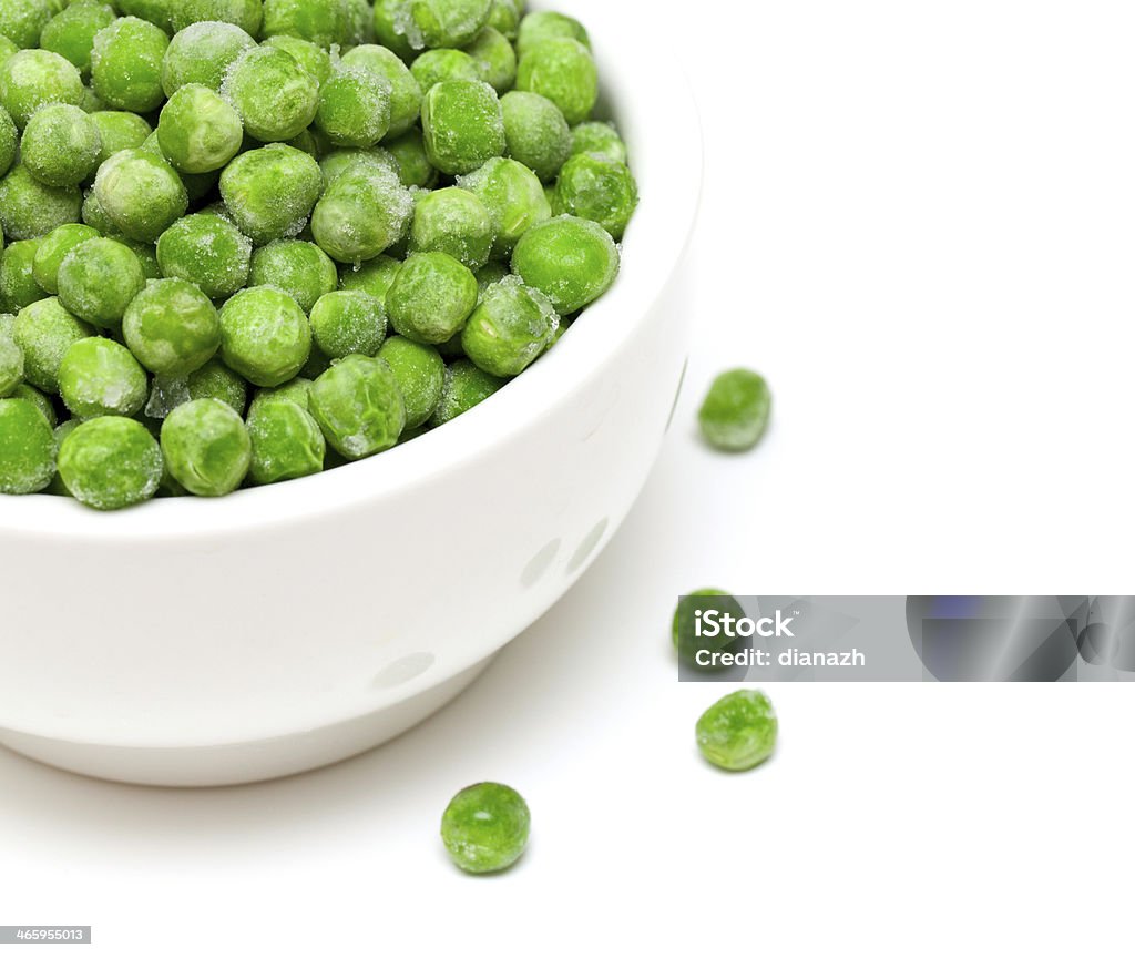 frozen green peas frozen green peas in a bowl and empty space for your text Bowl Stock Photo