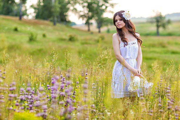 istock Young beautiful woman in a summer field 465956287