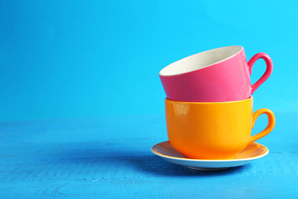 istock Colorful cups on blue wooden background 465956484