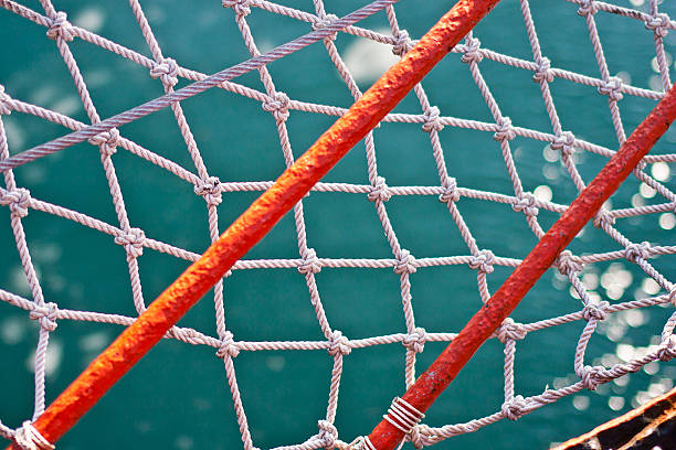 istock Orange stripes and rope net over turquoise ocean 465956730
