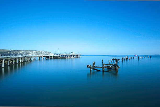 swanage piers antiga e nova - swanage imagens e fotografias de stock