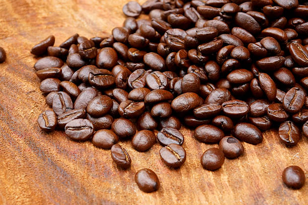 istock Roasted coffee beans on wood. (Arabica coffee) 465958581