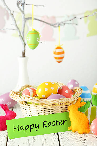 istock Easter eggs in basket on white wooden background 465961076