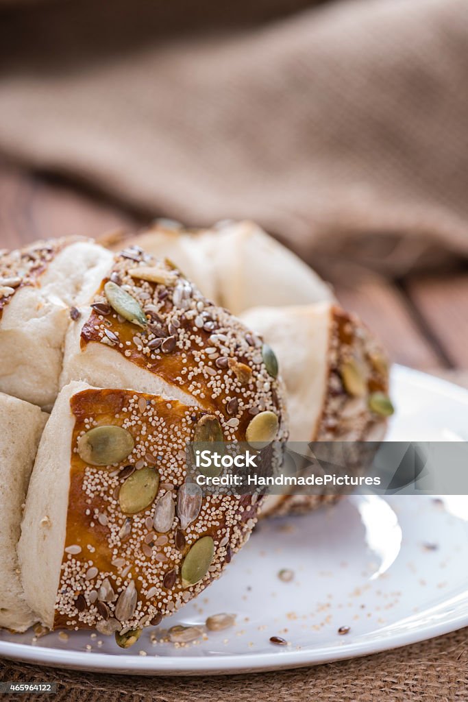 Fresh baked Pretzel Rolls (with seeds) Fresh baked Pretzel Rolls (with mixed seeds) on rustic wooden background 2015 Stock Photo