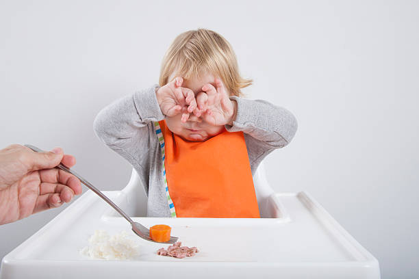 baby doesnt like carrot stock photo