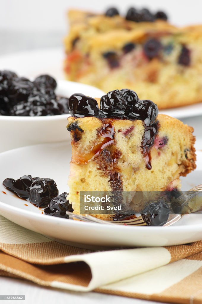 Fruit pie Slices of fruit pie with berries in white plates and jam in bowl. 2015 Stock Photo