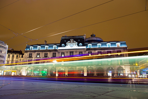 Clermont-Ferrand, France - February 18, 2015: Opera-Theatre building view at the evening while tram is passing via Place de Jaude square, Clermont-Ferrand, France