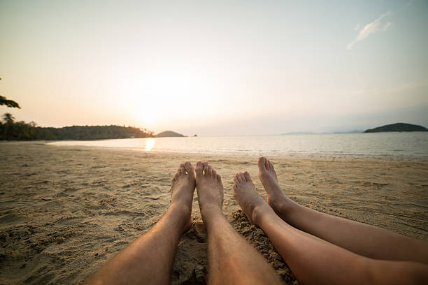 Human's feet relaxing on a tropical beach