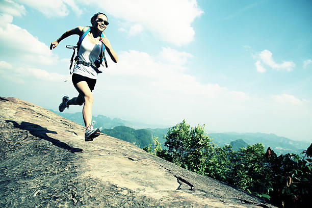 istock hiking woman running on mountain peak 465968586