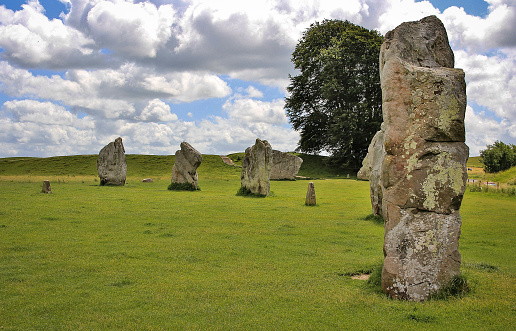 White, puffy clouds floating over one of the larger stone circles in Avebury, ancient neolithic site dating to around 2600 BCE.
