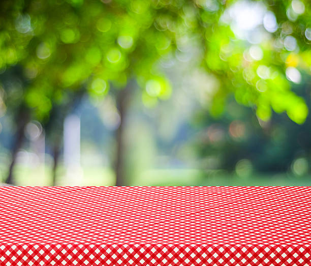 istock Table with red tablecloth and blur trees with bokeh background 465972388