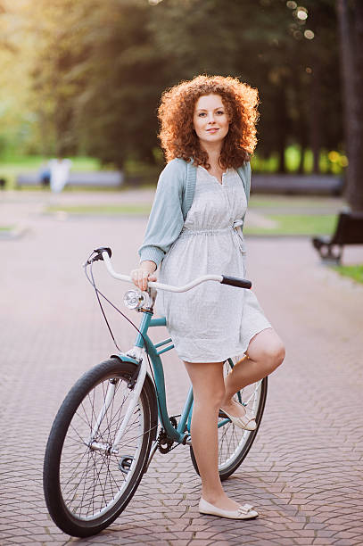 istock Beautiful woman with bike 465973194