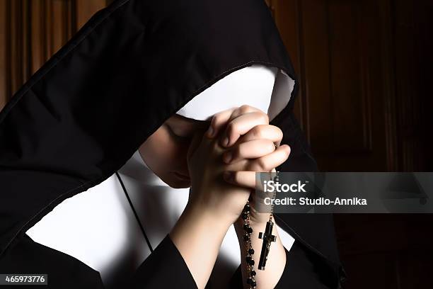 Nun Folding Hands Holding A Rosary Praying Stock Photo - Download Image Now - Nun, Catholicism, Praying