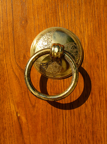 Antique wooden brown door with golden handle
