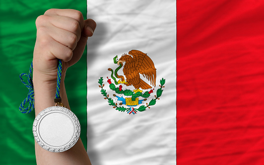 Holding silver medal for sport and national flag of mexico