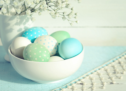 Easter eggs in a bowl and flowers. Vintage