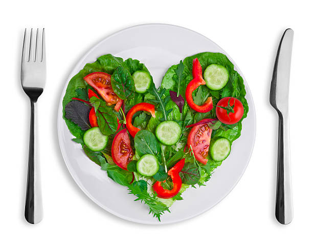 istock Heart shape of various vegetables and herbs on white plate 465977465