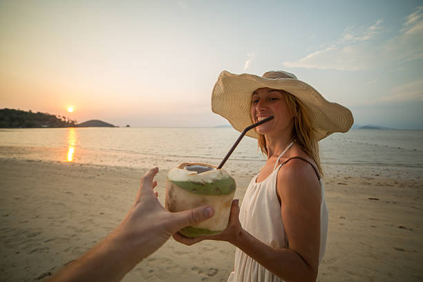 istock Couple drinking coconut on tropical beach 465977718
