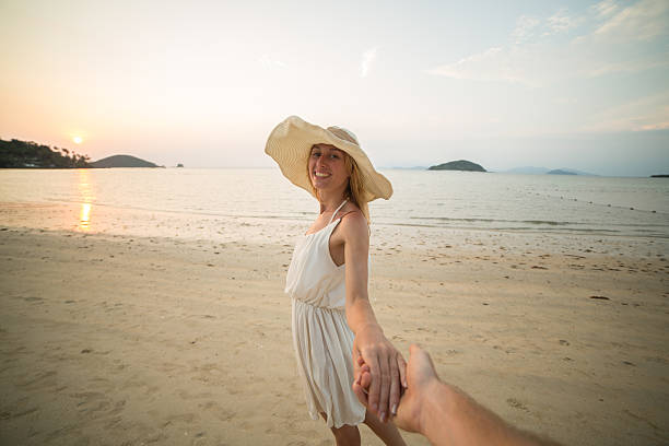 istock Couple on beach holding hands 465977736