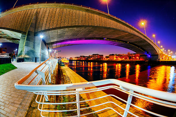 Night View of the River Clyde and Kingston Bridge, Glasgow Colourful view from below the Kingston Bridge carrying the M8 motorway over the River Clyde in Glasgow, Scotland. clyde river stock pictures, royalty-free photos & images