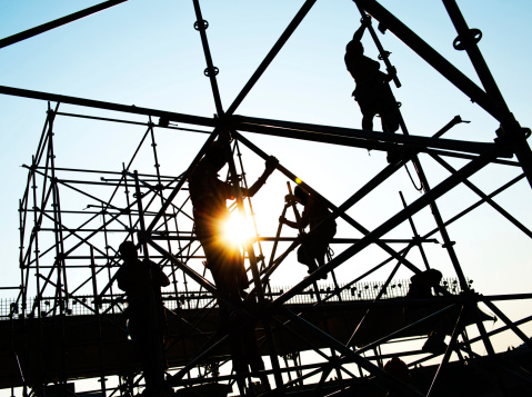 Construction workers working on scaffolding