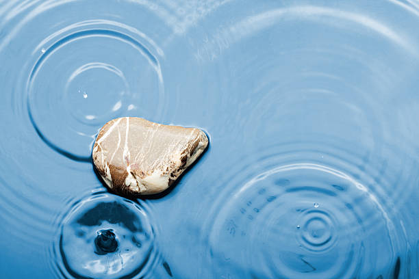 Brown striped stone in the water under the rain, can use, as background