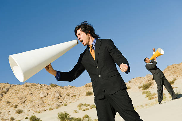 istock Businessmen Screaming Through Desert 465987760