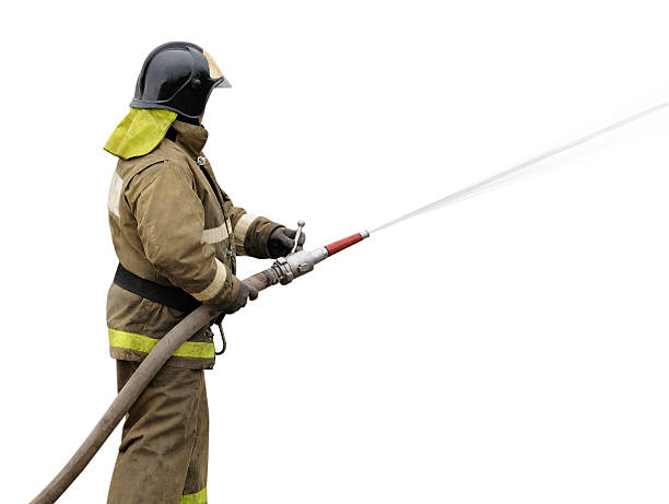 Firefighter working with fog nozzle Firefighter working with fog nozzle. Isolated on white background fire hose photos stock pictures, royalty-free photos & images