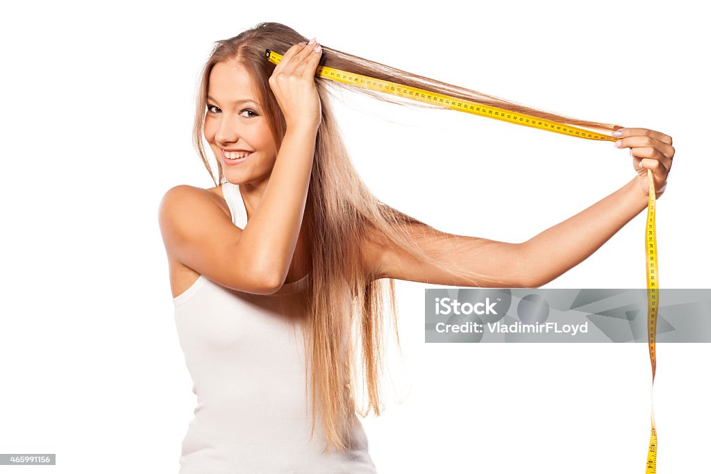 Beautiful girl measures her hair with a measuring tape beautiful girl measures her hair with a measuring tape 2015 Stock Photo