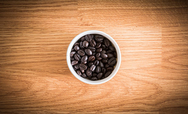 istock roasted coffee beans in white cup on wooden background 465993364
