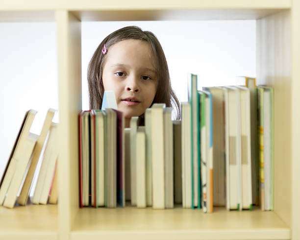 istock Young girl looking at books on bookshelf 465993670