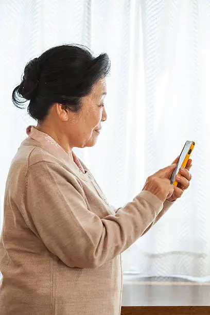 The old woman using smart phone.