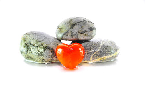 Rocks and heart against white background.