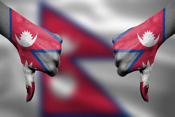 failure of Nepal - hands gesturing thumbs down in front of flag