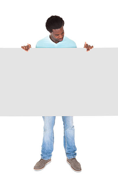 istock Young Man Standing Behind The Placard 465997699