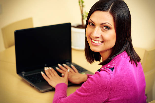 istock Middle-aged smiling woman using laptop 465998129