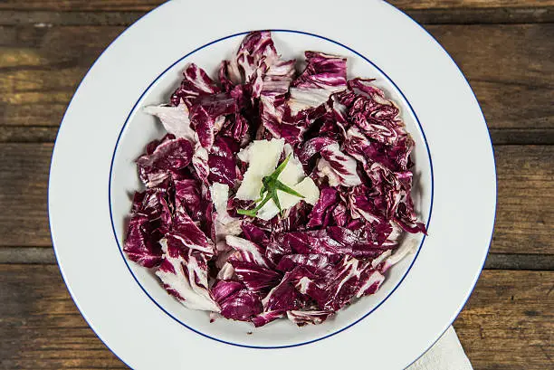 Red cabbage in a plate with flakes of parmesan