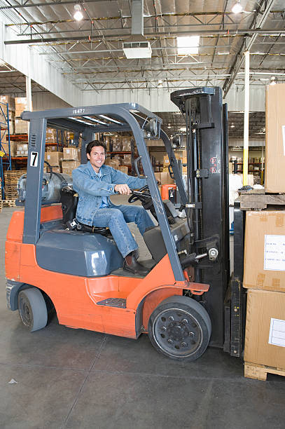 istock Man Operating Forklift Truck In Warehouse 465998920