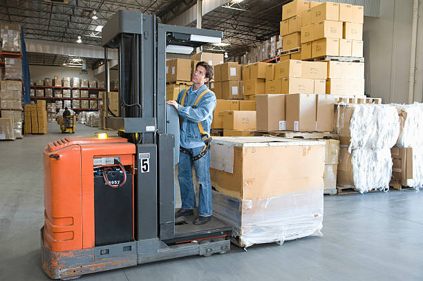 istock Man Operating Forklift Truck In Warehouse 465998922