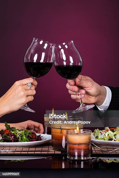 Couple Tossing Wine Glass Stock Photo - Download Image Now - Adult, Adults Only, Alcohol - Drink