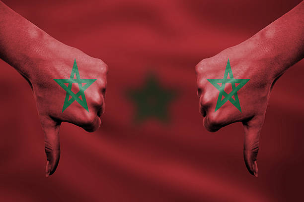 failure of Morocco - hands gesturing thumbs down in front of flag