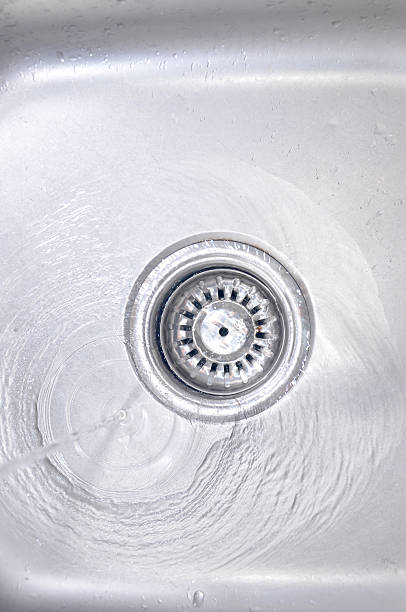 istock Water Flowing Down To The Hole In A Kitchen Sink 465999824